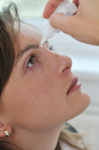 Woman using eye drops