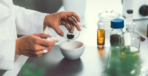 Homeopathy lab. Homeopath preparing alternative herbal medicines.